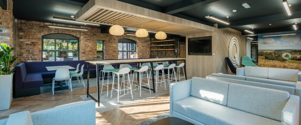 Quickline collaboration space with high table and wall-mounted TV
