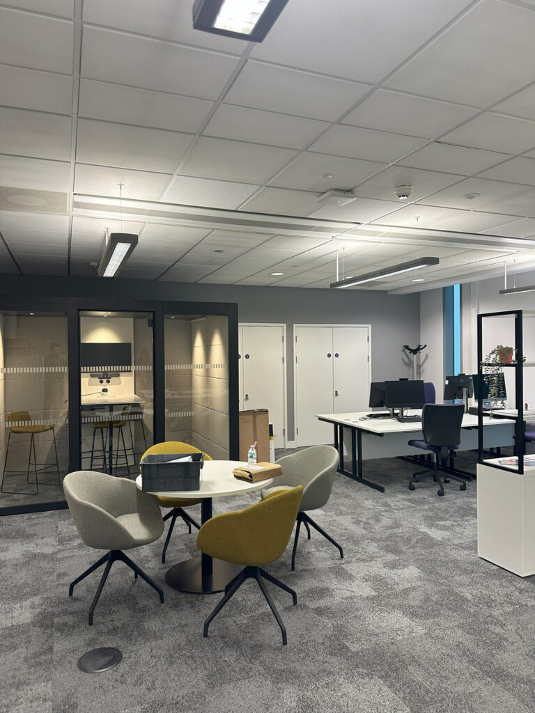 university office with desks, glass meeting pod and breakout table